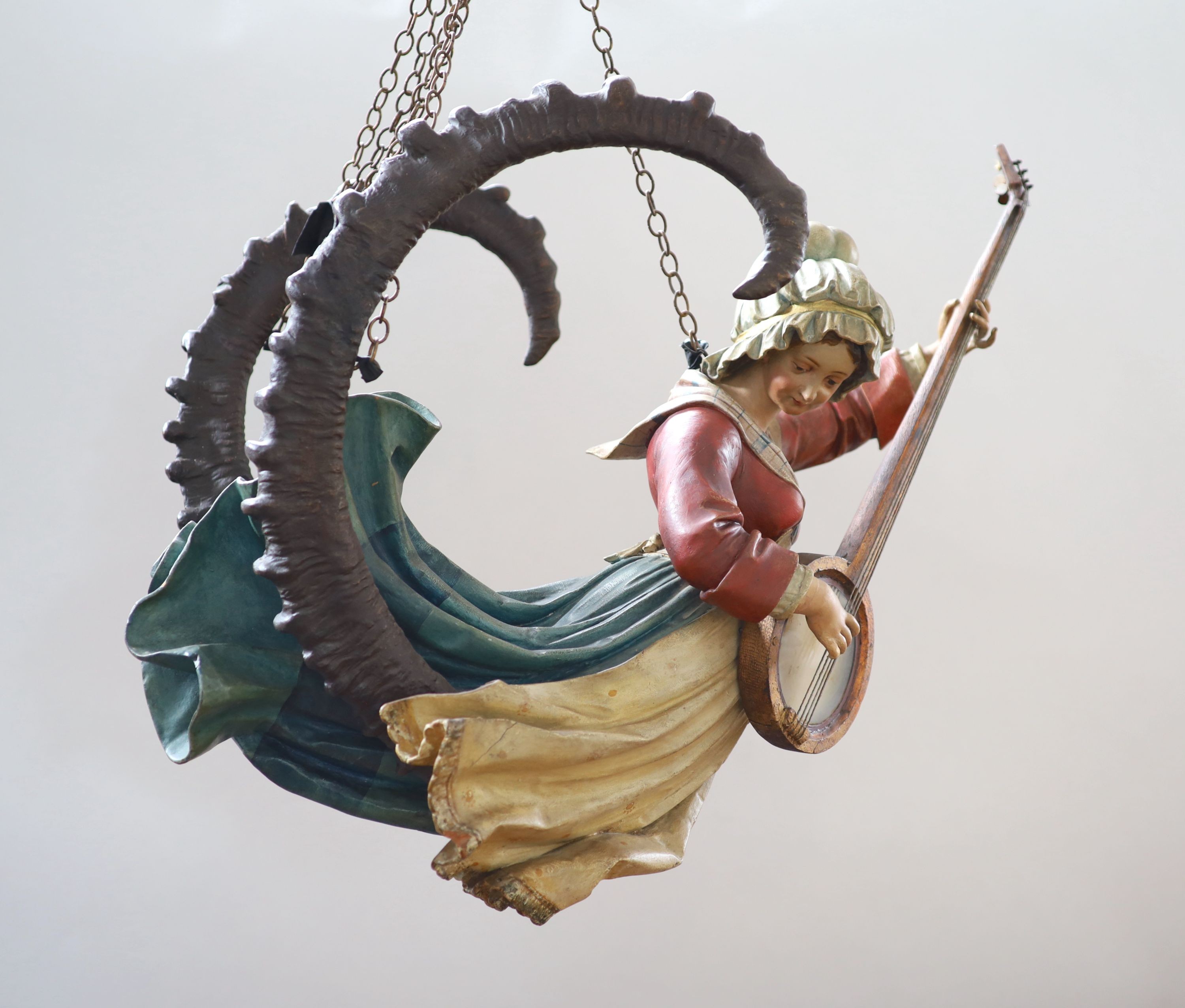 A late 19th century carved and painted wood Lusterweibchen H 60cm. W 80cm.